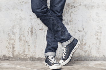 man wearing blue denim jeans with converse