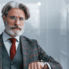 man in a suit with salt and pepper hair and beard