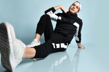 hipster wearing a black tracksuit, athletic gear as stylish men's outfits